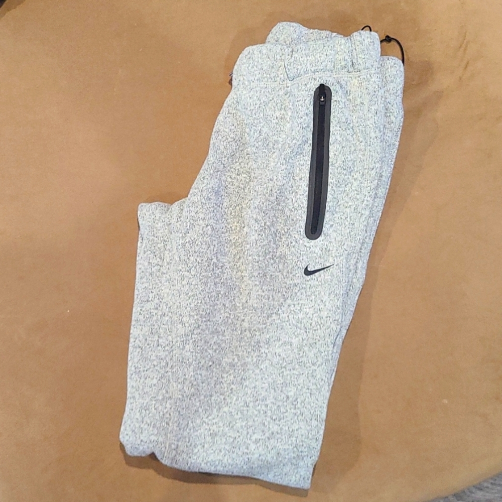 Gray ladies Nike warm sweats with drawstring ankles.
